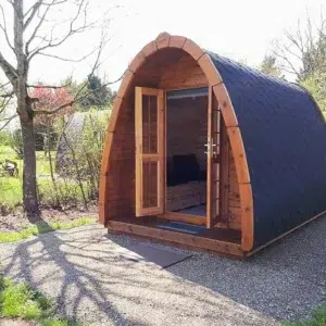 Wooden camping pod, open front doors revealing interior