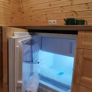 Wooden camping pod, open under-counter refrigerator