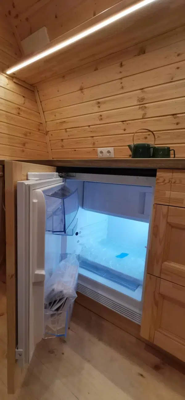 Wooden camping pod, open under-counter refrigerator