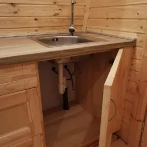 Wooden camping pod, open under-sink cabinet