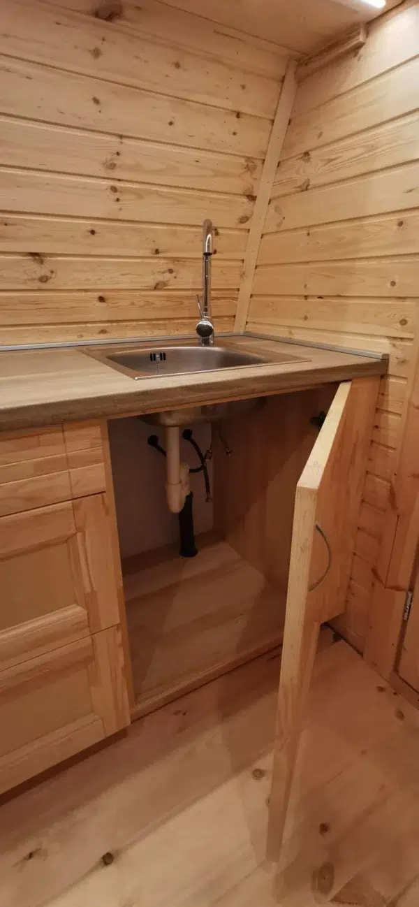 Wooden camping pod, open under-sink cabinet