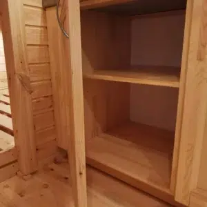 Wooden camping pod, open wooden storage shelves