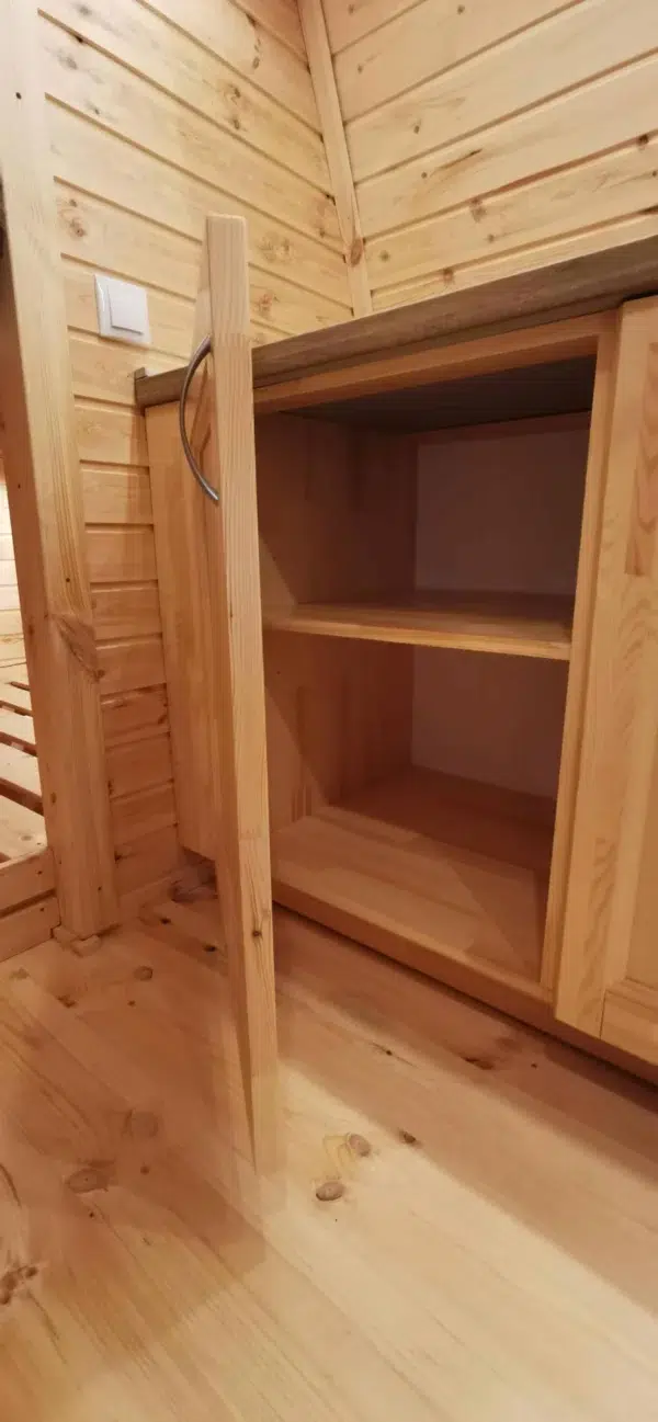 Wooden camping pod, open wooden storage shelves