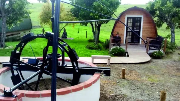 Wooden camping pod, outdoor seating area beside camping pod