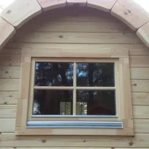 Wooden camping pod, rear window and curved roof trim