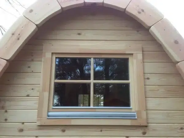 Wooden camping pod, rear window and curved roof trim