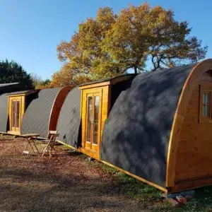 Wooden camping pod, row of camping pods outdoors