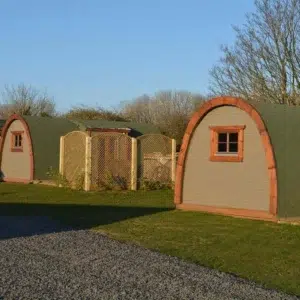 Wooden camping pod, row of pods with side entrances