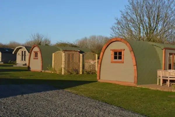Wooden camping pod, row of pods with side entrances