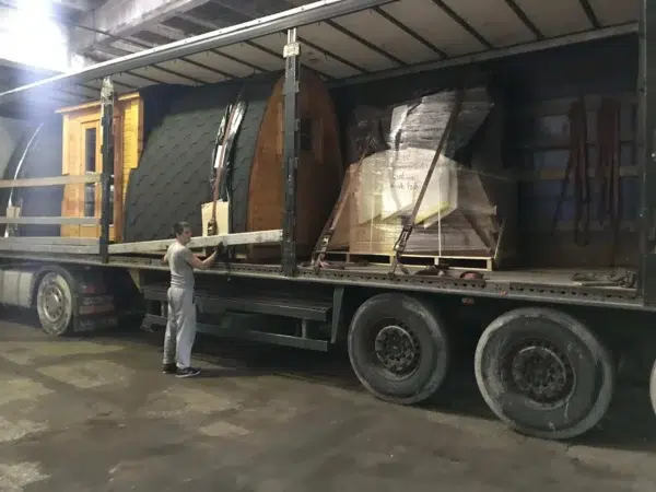 Wooden camping pod, several pods secured on a transport truck