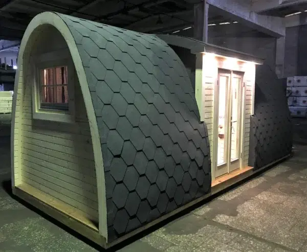 Wooden camping pod, side and end exterior with entrance lighting