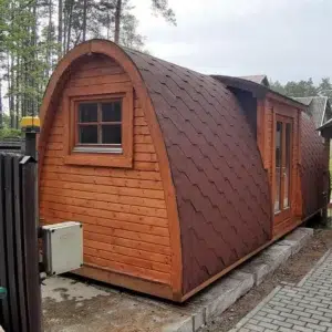 Wooden camping pod, side and end exterior with shingle roof