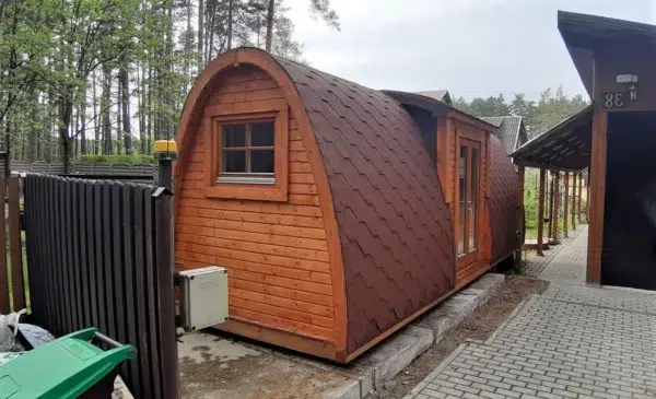 Wooden camping pod, side and end exterior with shingle roof