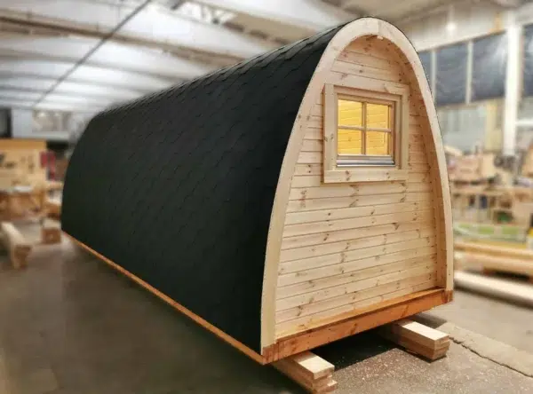 Wooden camping pod, side and rear exterior with rectangular window