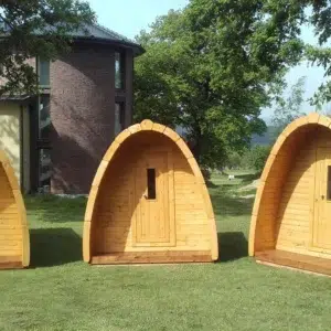 Wooden camping pod, small camping pods on a lawn