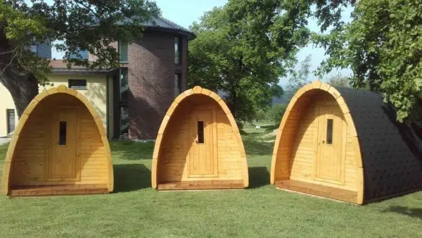 Wooden camping pod, small camping pods on a lawn