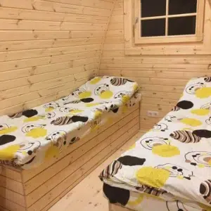 Wooden camping pod, twin beds beneath rear window
