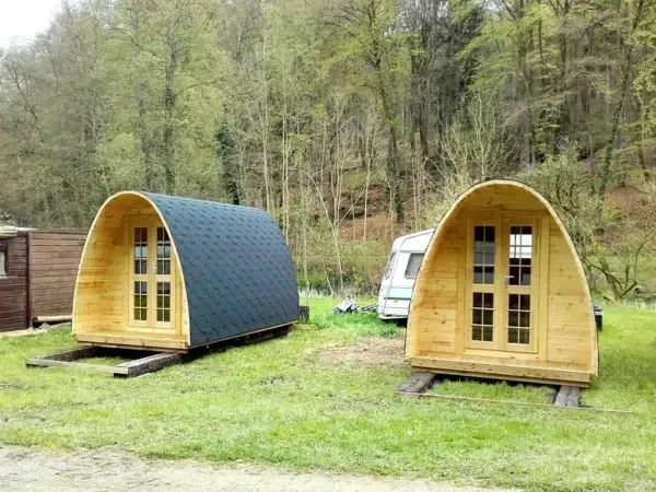 Wooden camping pod, two camping pods on a grassy site