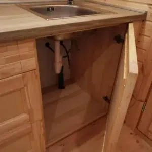Wooden camping pod, under-sink cabinet storage and plumbing