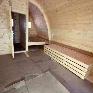 Wooden camping pod, unfinished interior with stacked boards