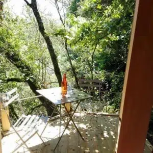 Wooden camping pod, view through entrance to a wooded deck