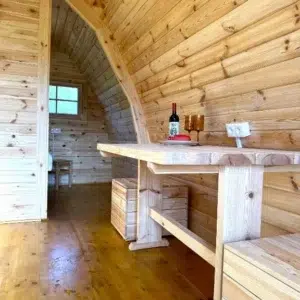 Wooden camping pod, wooden dining table and bench