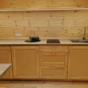 Wooden camping pod, wooden kitchenette with sink and hob