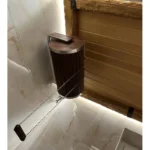 TESLI 20 L thermo basswood sauna shower cylinder with stainless steel insert, installed beside a tiled shower wall with pull chain