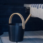 Rento Black sauna ladle with heat-treated bamboo handle in a sauna setting