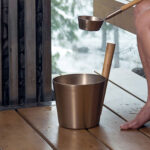 Rento Champagne sauna ladle with heat-treated bamboo handle in a sauna setting
