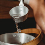 Rento Natural sauna ladle with heat-treated bamboo handle in a sauna setting
